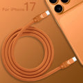 Top view of coiled orange 240W silicone fast charging cable with anodized connectors, product shot. C to C